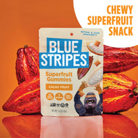 Blue Stripes Superfruit Gummies cacao fruit flavor pouch displayed in front of whole cacao pods on an orange background.